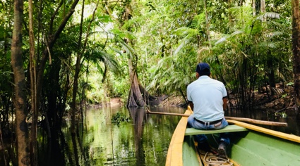Nativo del Amazonas navegando sobre un bote en el río Amazona Colombia | Colombian Tourist